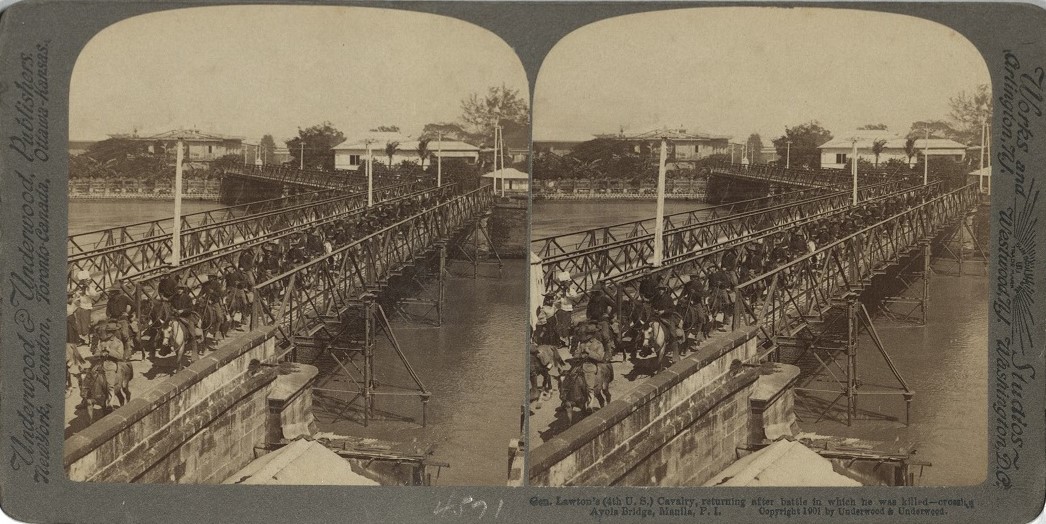 Gen. Lawton’s (4th U.S.) Cavalry, returning after battle in which he was killed – crossing Ayola [Ayala] Bridge, Manila, P. I.